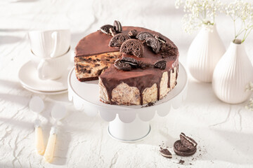 Tasty Cookie cheesecake with chocolate glaze on white.