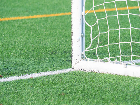 Empty soccer goal on vibrant green field with white lines