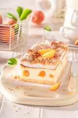 Homemade peach cheesecake with foam and cocoa.