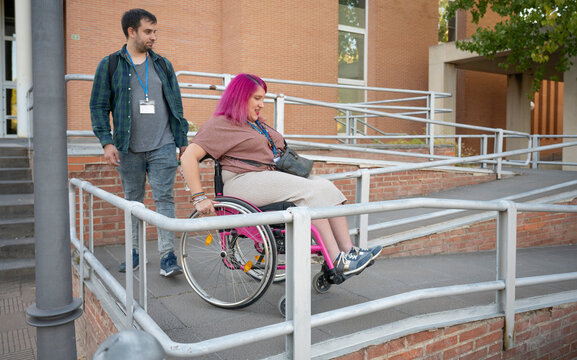 College couple navigating campus with wheelchair accessibility