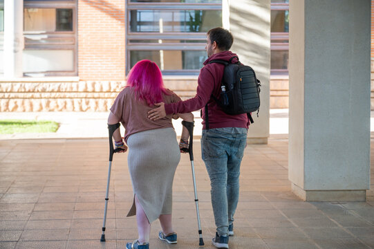 Couple in college setting, woman with disability due to spina bifida