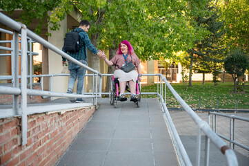 Couple in college, woman using wheelchair due to spina bifida