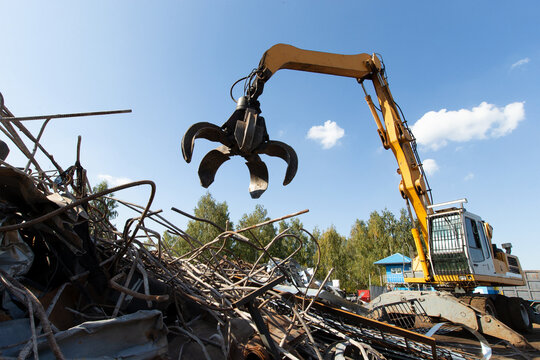Excavator for loading scrap metal.