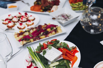 Catering table, beautifully decorated banquet with variety different food snacks appetizers on christmas corporate birthday party event or wedding celebration, canape, salad, delicatessen setting