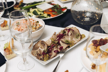 Catering table, beautifully decorated banquet with variety different food snacks appetizers on christmas corporate birthday party event or wedding celebration, canape, salad, delicatessen setting