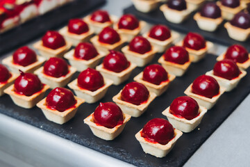 Catering table, beautifully decorated banquet with variety different food snacks appetizers on christmas corporate birthday party event or wedding celebration, canape, salad, delicatessen setting