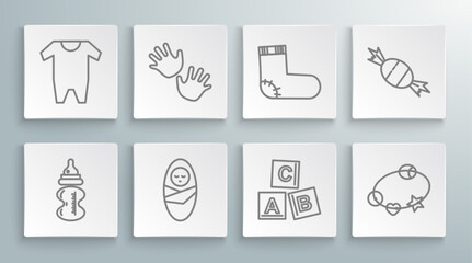 Fototapeta na wymiar Set line Baby bottle, hands print, Newborn baby infant swaddled, ABC blocks, Rattle toy, socks clothes, Candy and icon. Vector