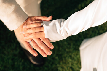 hands of newlyweds with rings