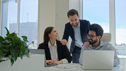 Mentor help colleagues with corporate work on laptop businessman teaching businesswoman analyze...
