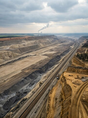 Aerial View of Open Pit Mine with Machinery and Smokestacks