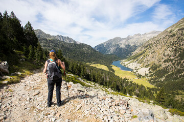 Young hiker woman in Vall de Boi, Aiguestortes and Sant Maurici National Park, Spain