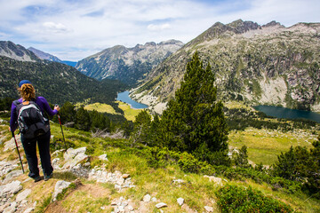 Young hiker woman in Vall de Boi, Aiguestortes and Sant Maurici National Park, Spain