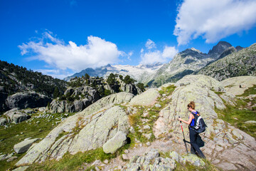 Fototapeta premium Young hiker woman in Vall de Boi, Aiguestortes and Sant Maurici National Park, Spain