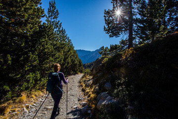Young hiker woman in autumn in Aiguestortes and Sant Maurici National Park, Spain