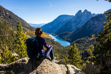 Young hiker woman in autumn in Aiguestortes and Sant Maurici National Park, Spain