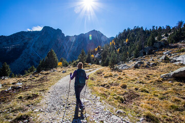 Young hiker woman in autumn in Aiguestortes and Sant Maurici National Park, Spain