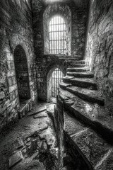 Obraz premium Ancient Stone Staircase Winding Through Dark Castle Passage