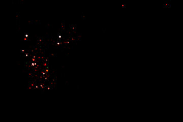 Red blurred bokeh lights on black background. Glitter sparkle confetti