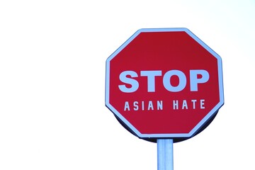 Stop asian hate concept. social issues. letters written on red stop sign.