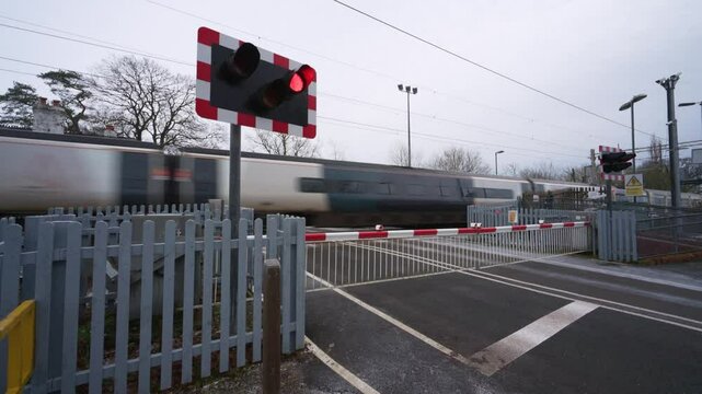 BARLASTON, STAFFORDSHIRE, ENGLAND - JANUARY 8 2025: Avanti West Coast train passing through a level crossing at Wedgwood.