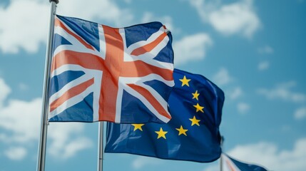 Flags of the United Kingdom and the European Union against a blue sky.