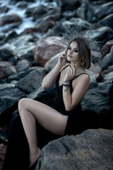 Portrait of a beautiful girl with bright makeup and beautiful hair, sitting with her back to the...