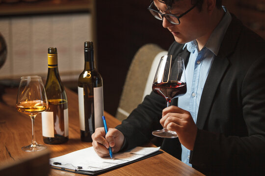 Sommelier Writing Notes at Wine Tasting Table