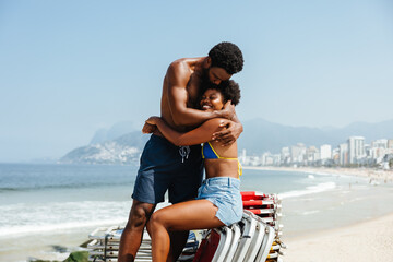 Romantic couple embracing by the seaside at Ipanema Beach