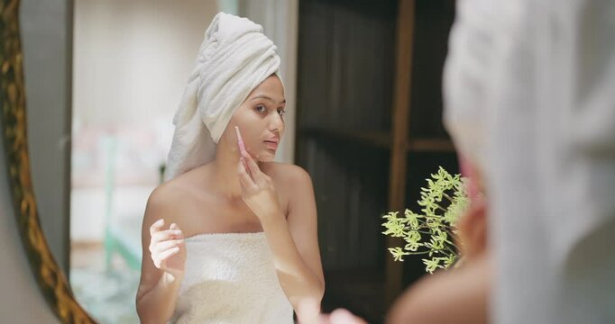 Indian young adult gen z woman lady hold blade razor do self skin care home teen age female girl wrapped towel on head body look mirror use tool shave her wet face clean upper lip cheek facial hair