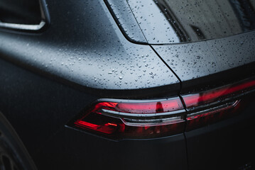 Modern rear light on new matte black automobile