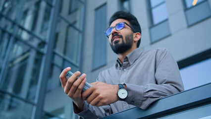 Happy successful wealthy rich man smiling millionaire businessman on balcony outside hold money...