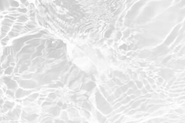 White water with ripples on the surface. Defocus blurred transparent white colored clear calm water surface texture with splashes and bubbles. Water waves with shining pattern texture background.