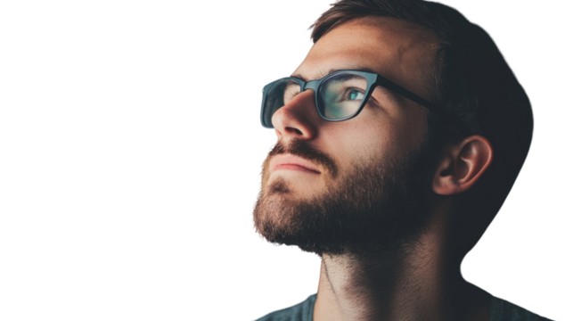 A thoughtful young man with glasses gazes upwards, reflecting a sense of curiosity and contemplation. Perfect for concepts of inspiration and dreaming.