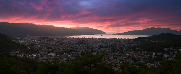 Panoramic sunrise view of the holiday city of Marmaris. Beautiful sky in autumn season. Mediterranean coast. Mugla province, Turkey country 