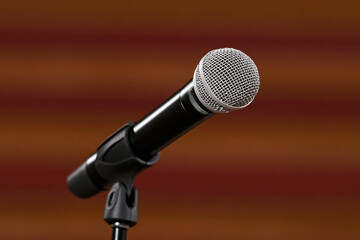 Fototapeta premium A microphone with a silver dome sits on a stand