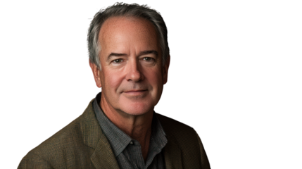 Portrait of a confident middle-aged man in a blazer, smiling gently with a relaxed expression, against a black background.