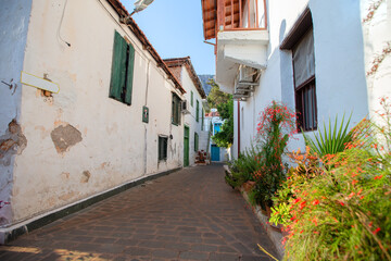 Narrow tourist streets of the Turkish city of Kas with white houses and colored windows. Beautiful ethnic resort town.