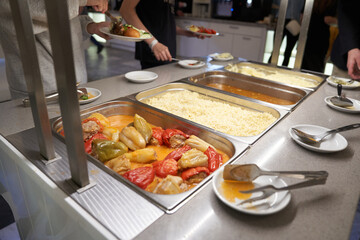 A buffet with Russian dishes, which features traditional dishes in metal containers. With space to copy. High quality photo