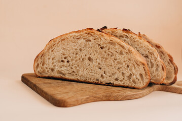 sliced bread on a wooden board and beige background