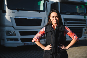 Portrait of a beautiful woman truck driver standing in the parking lot