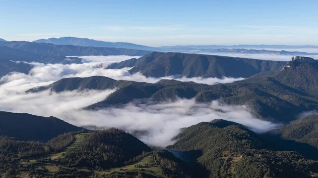 Clouds timelapse over forested mountains and blue sky in Osona, Barcelona, Spain