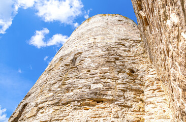 Stone tower of the ancient Izborsk fortress against a blue sky. Izborsk, Pskov region, Russia....