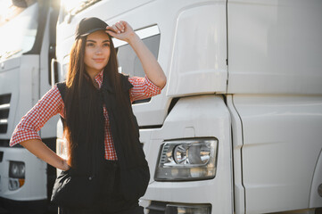 Young woman professional driver on a parking lot. People and industrial transportation concept