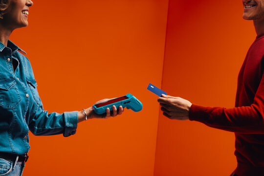 Tap to pay technology for seamless shopping transaction in orange monochromatic set