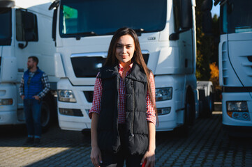 Female truck driver standing in front of her truck after she successfully completed her first tour