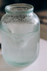 Water swirls in a glass jar. Stirring the liquid