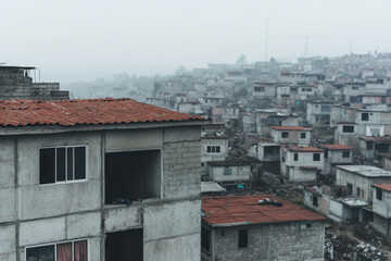 A city with many small houses and a large building with a red roof