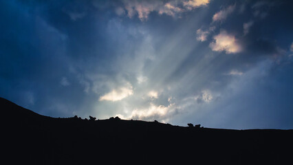 sun raus penetrate the grey clouds over the Caucasus Mountains