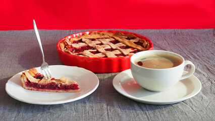 Cherry tart basket Piece white plate, black coffee for breakfast on red curtain, grey background....