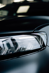 front headlight of a black matte car